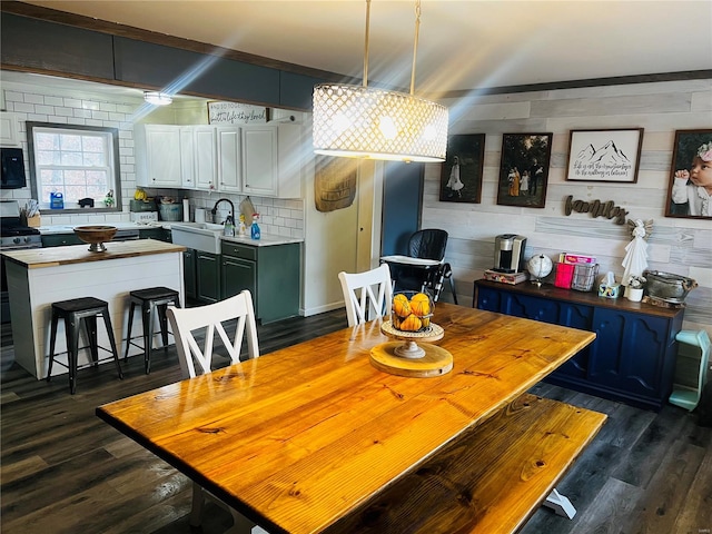 dining space with dark hardwood / wood-style floors and sink