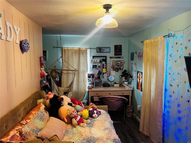 bedroom featuring a textured ceiling and dark wood-type flooring