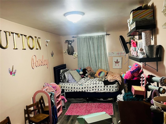 bedroom with hardwood / wood-style flooring