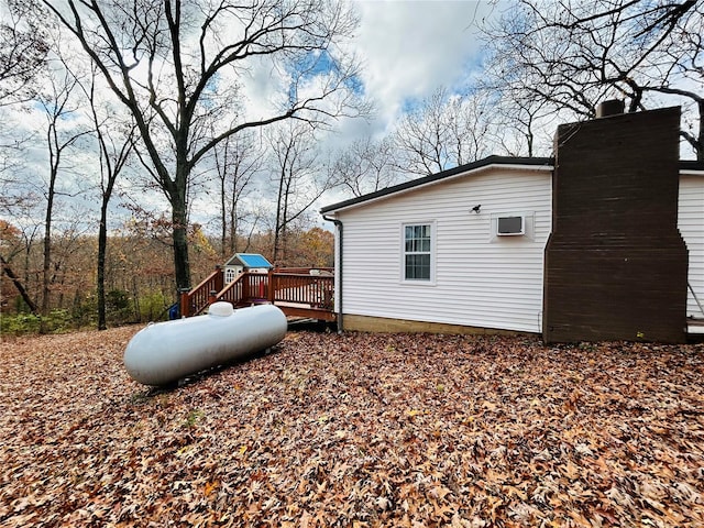 view of side of home with a wooden deck