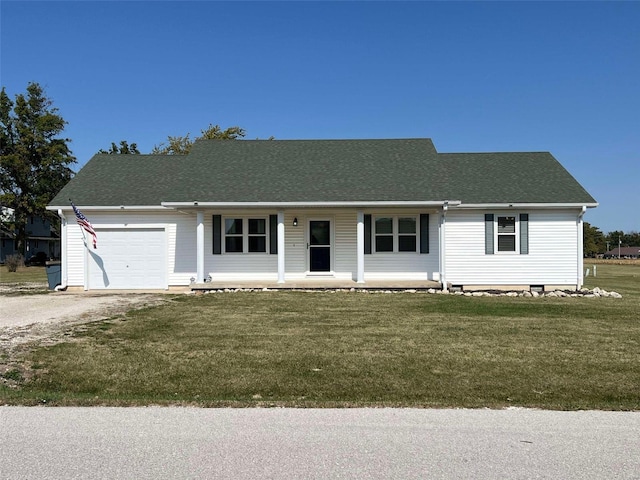 single story home featuring covered porch, a front yard, and a garage