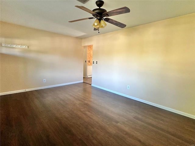 empty room featuring ceiling fan and dark hardwood / wood-style flooring