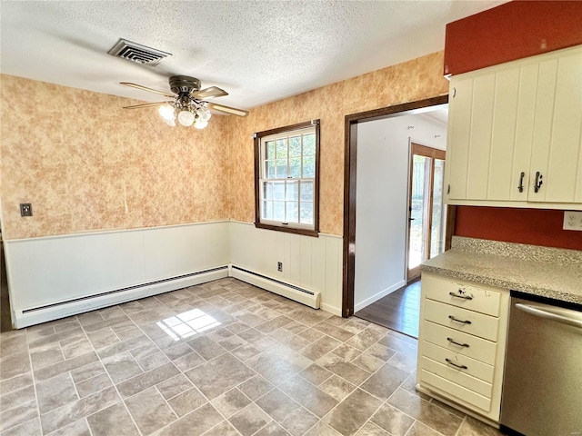 interior space featuring dishwasher, a baseboard heating unit, ceiling fan, a textured ceiling, and cream cabinetry