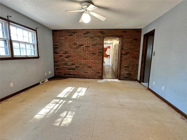 unfurnished room featuring ceiling fan and a textured ceiling