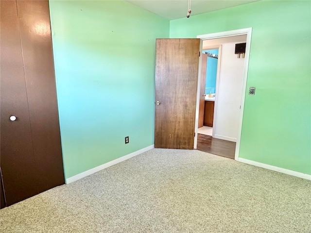 unfurnished bedroom featuring carpet flooring and a closet