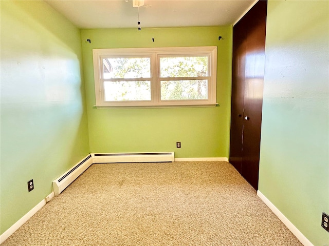 empty room featuring carpet flooring and baseboard heating