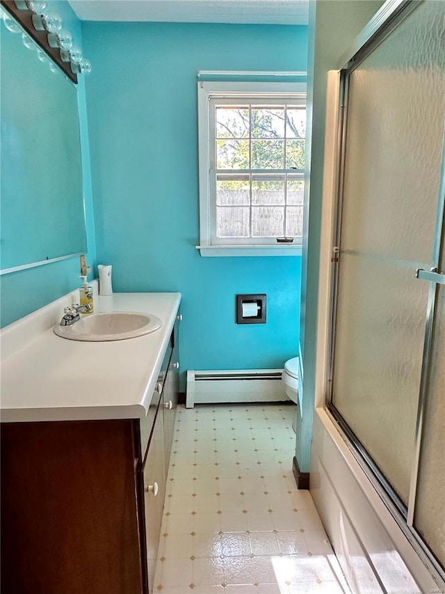 bathroom with vanity, toilet, and baseboard heating