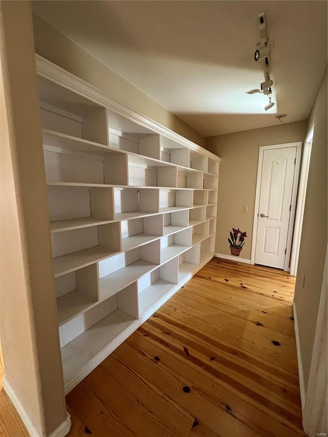 mudroom featuring track lighting and wood-type flooring