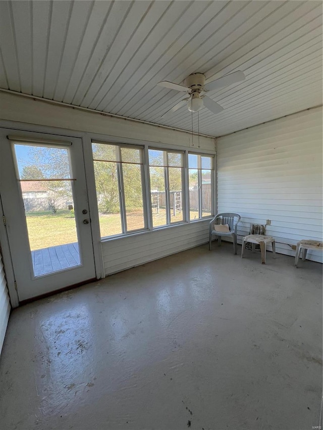 unfurnished sunroom featuring ceiling fan