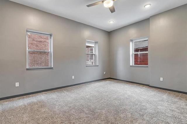 carpeted empty room with ceiling fan