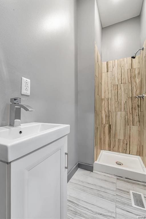 bathroom featuring vanity and a shower