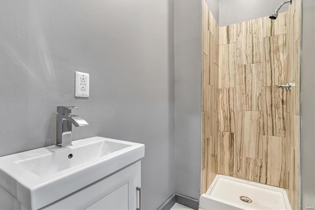 bathroom with vanity and a shower