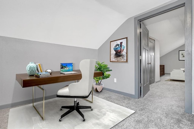 office area featuring lofted ceiling and light colored carpet