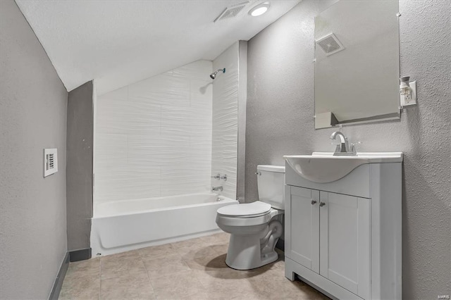 full bathroom with tiled shower / bath, vanity, toilet, tile patterned flooring, and vaulted ceiling