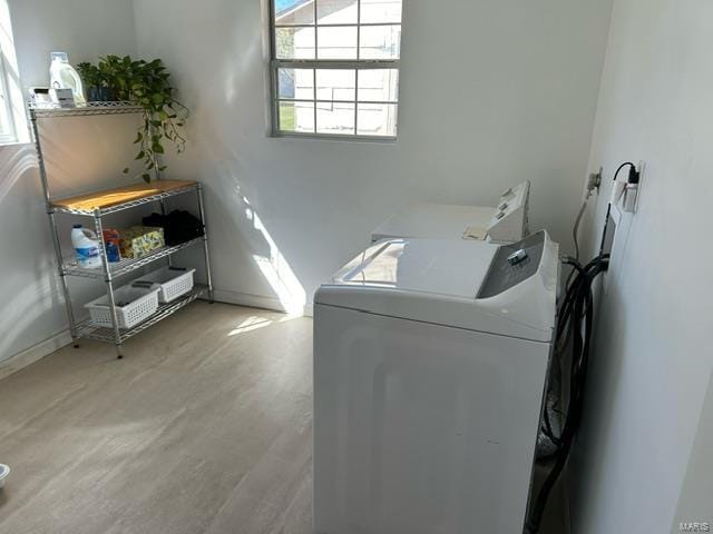 laundry area featuring independent washer and dryer and hardwood / wood-style floors