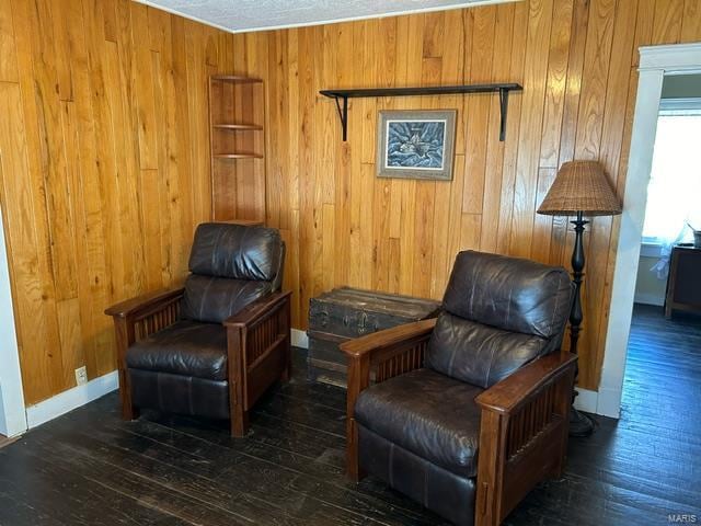 living area featuring wood walls and dark hardwood / wood-style flooring