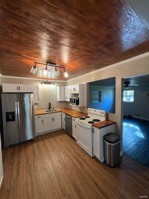 kitchen with butcher block countertops, white cabinetry, stainless steel appliances, wooden ceiling, and hardwood / wood-style flooring