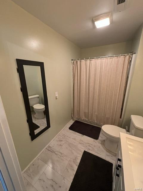 bathroom featuring vanity and toilet