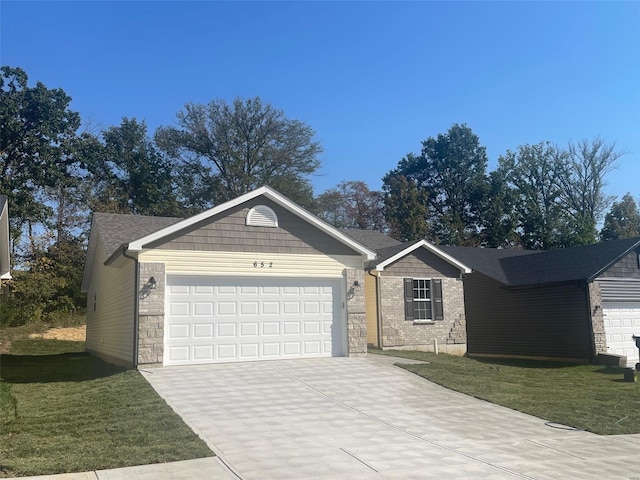 ranch-style house featuring a garage and a front lawn