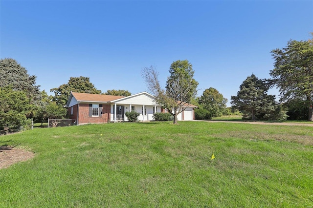 view of front of property with a front lawn and a garage