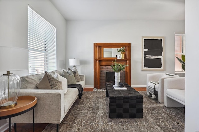 living room with a fireplace and dark wood-type flooring