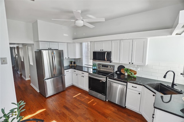 kitchen featuring ceiling fan, sink, backsplash, white cabinets, and appliances with stainless steel finishes