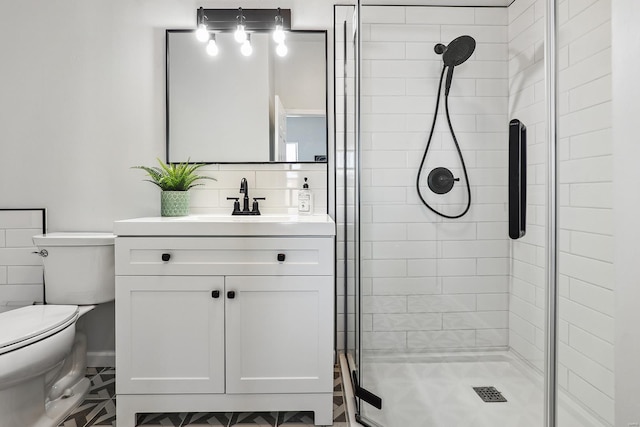 bathroom with vanity, toilet, and a shower with door