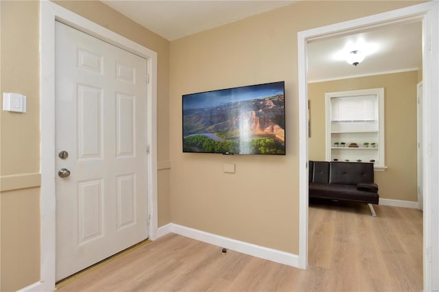 interior space featuring light hardwood / wood-style floors and ornamental molding