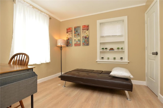 living area with crown molding and light wood-type flooring