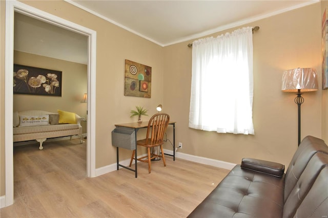 living area featuring crown molding and light wood-type flooring