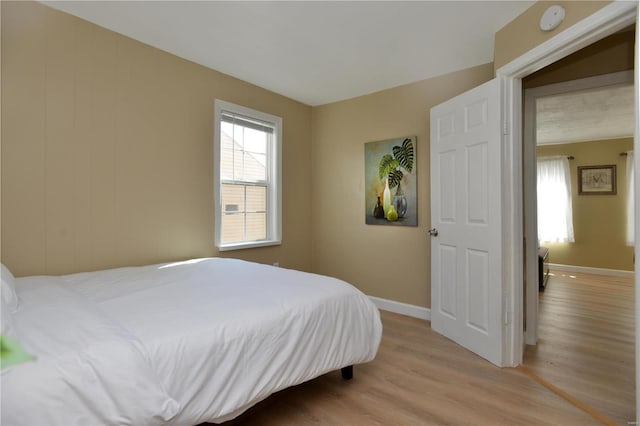 bedroom featuring light hardwood / wood-style flooring and a textured ceiling