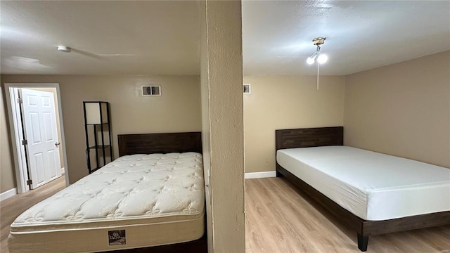 bedroom with light wood-type flooring