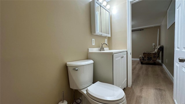 bathroom featuring vanity, hardwood / wood-style floors, and toilet