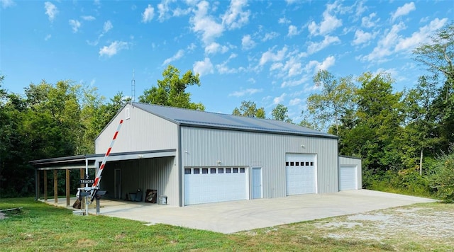 garage with a carport and a yard