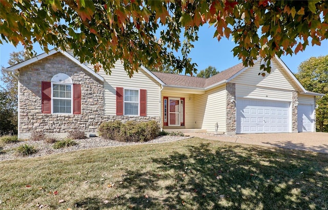 ranch-style house featuring a front lawn and a garage