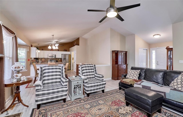 living room with lofted ceiling, light hardwood / wood-style flooring, and ceiling fan