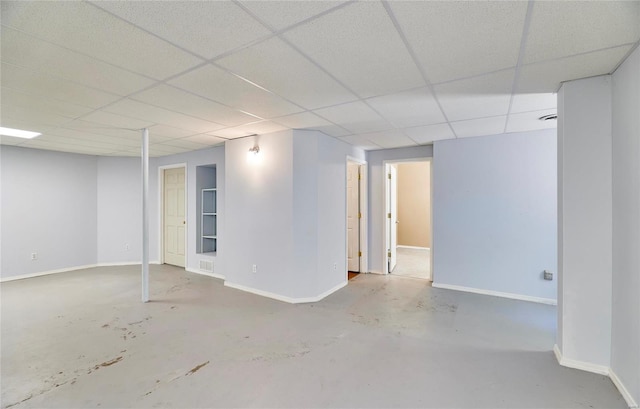 basement with a paneled ceiling