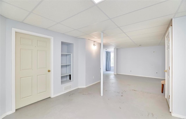 basement featuring a paneled ceiling