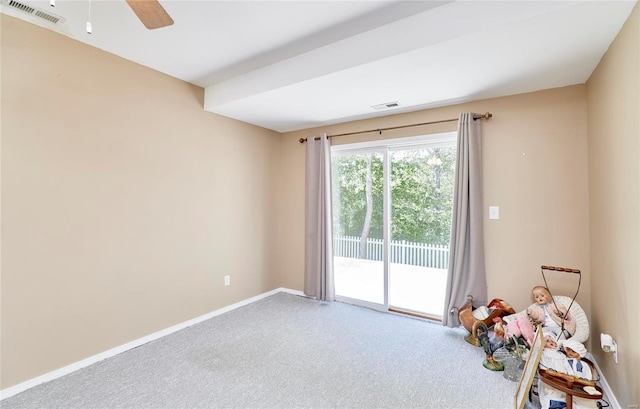 carpeted spare room with ceiling fan