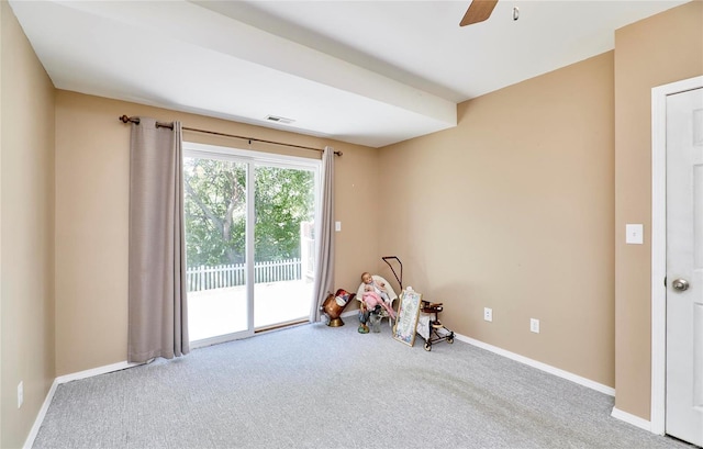 playroom featuring light carpet and ceiling fan