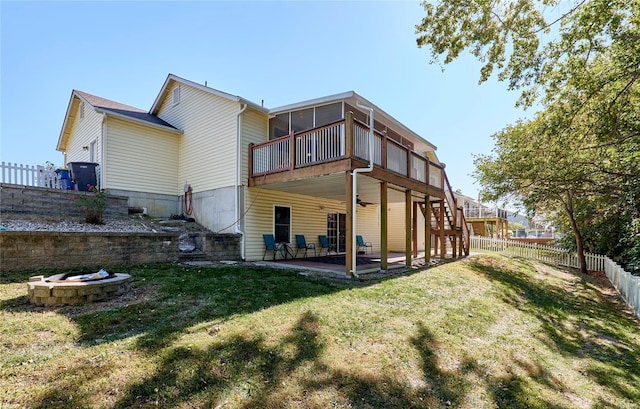 back of property with a yard and a patio area