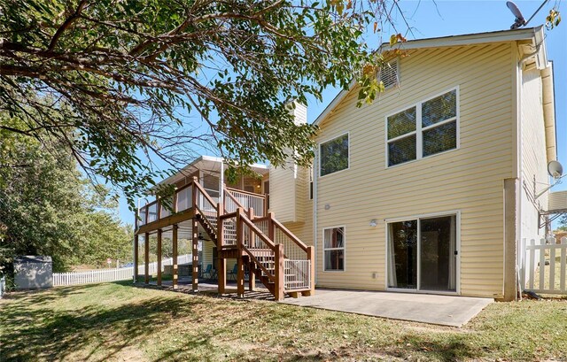 rear view of house featuring a patio and a lawn