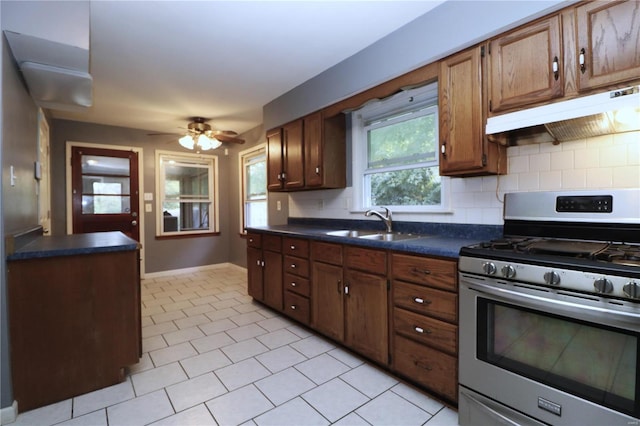 kitchen with ceiling fan, gas stove, sink, and backsplash