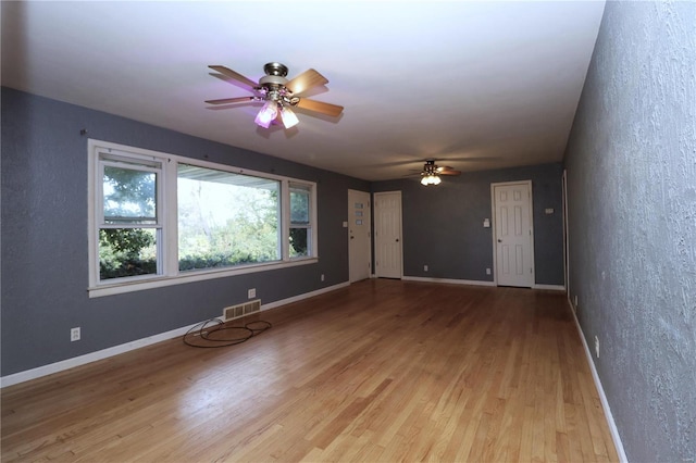 unfurnished living room with light hardwood / wood-style floors and ceiling fan