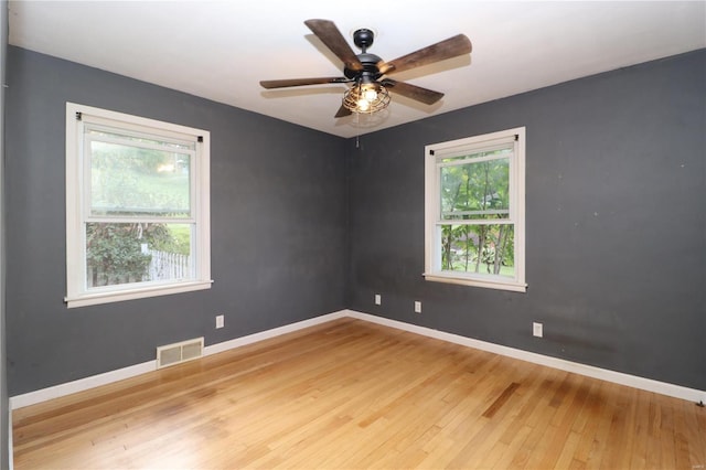 unfurnished room featuring ceiling fan, light hardwood / wood-style flooring, and plenty of natural light