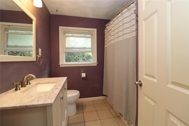 bathroom with toilet, tile patterned flooring, vanity, and curtained shower