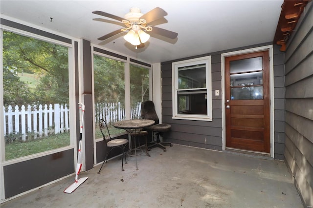 unfurnished sunroom with ceiling fan and a wealth of natural light