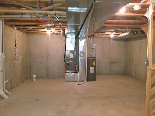 basement featuring water heater and heating unit