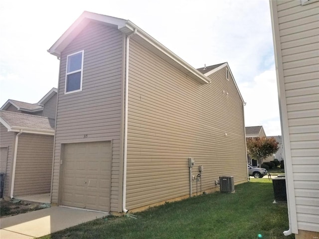 view of home's exterior with a garage, a lawn, and cooling unit