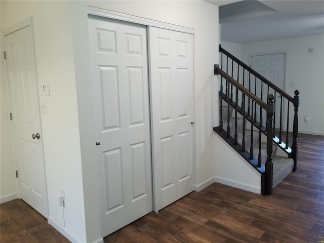 stairway with hardwood / wood-style floors